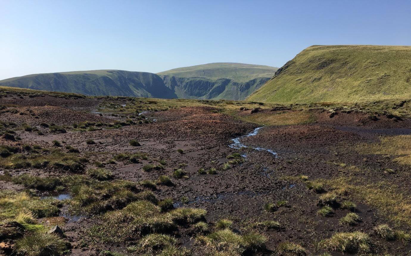 degraded peatland in the Cairngorms National Park, near Glenshee. The bare peat is vulnerable to both oxidation and erosion.